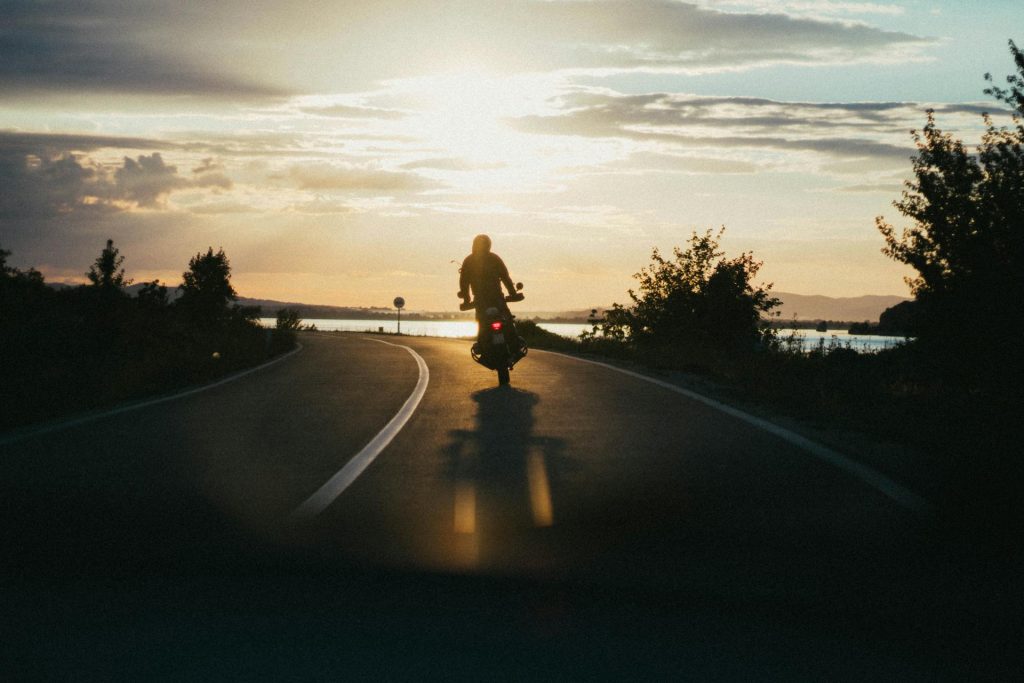 a person riding a motorcycle on a road - Motorcycle Accident Lawyer
