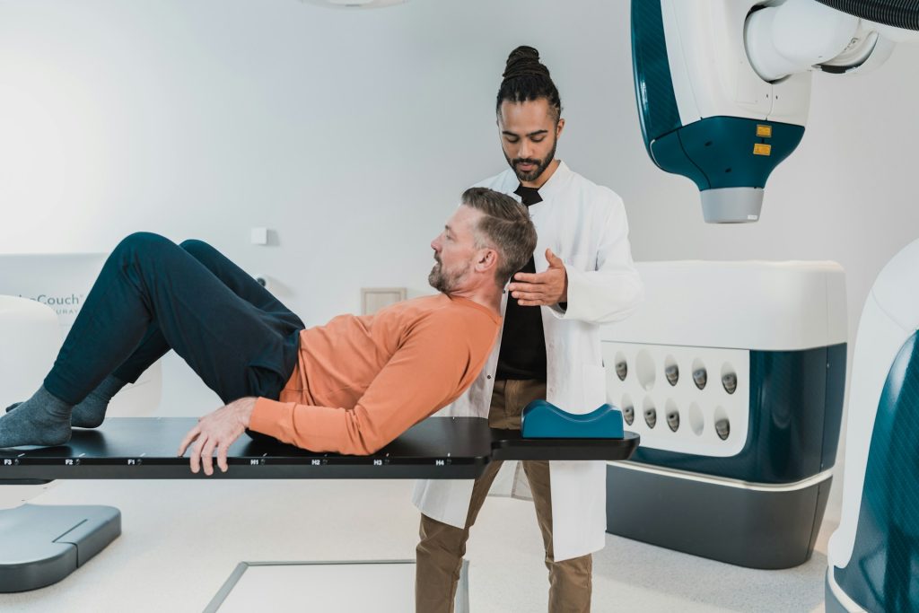 a man laying on a table in front of a robot - Car Accident Injury Claim