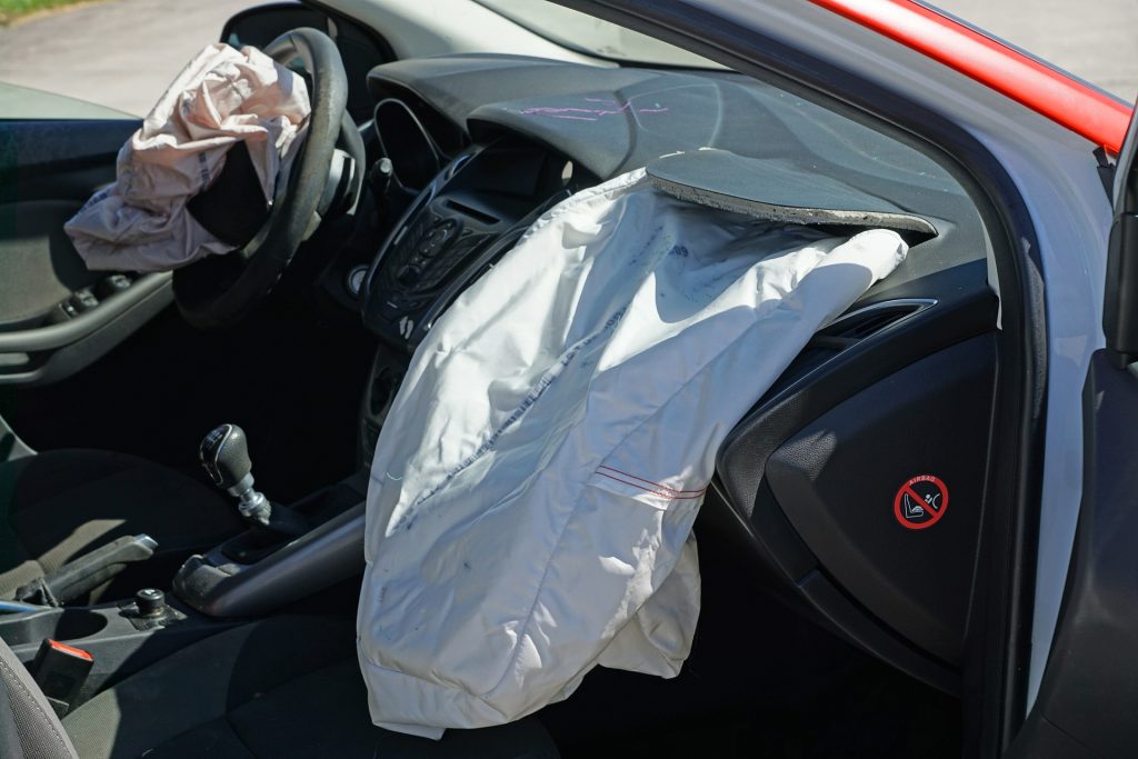 the interior of a car with the door open - Car Accident in Washington