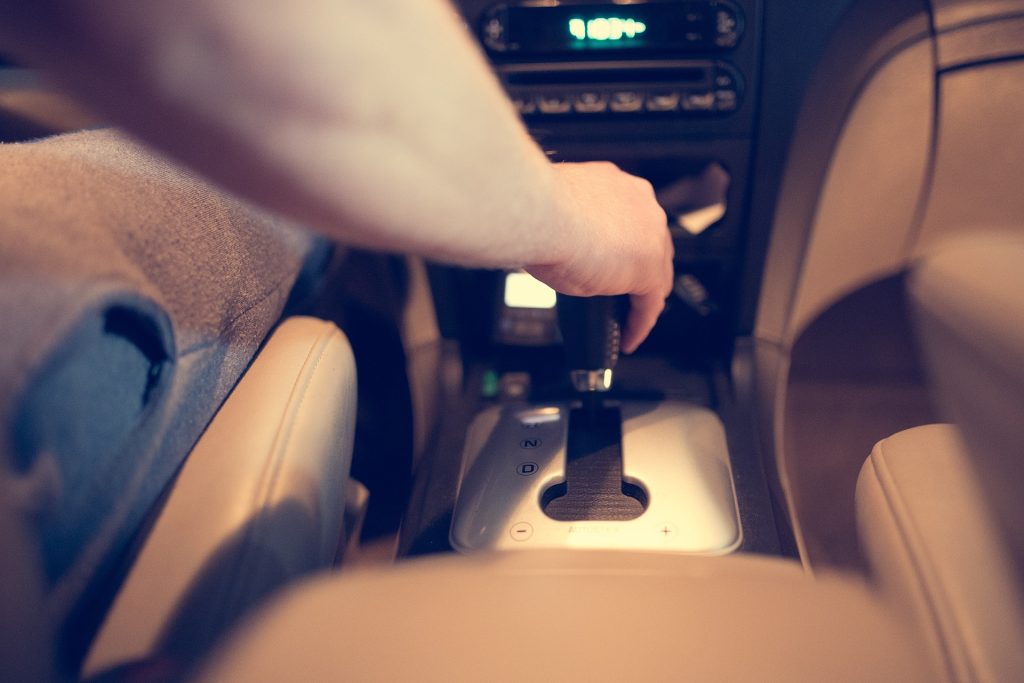 a person holding a remote control in a car - Drivers in Washington